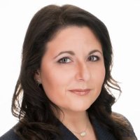 Portrait of a dark-haired woman in a black suit on a white background